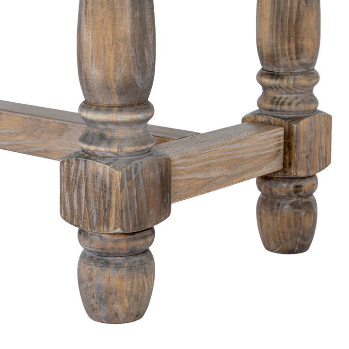 Close-up of a rustic wooden table leg with a turned ball finial and a square block connector, showing a weathered brown wood grain finish on a white background.