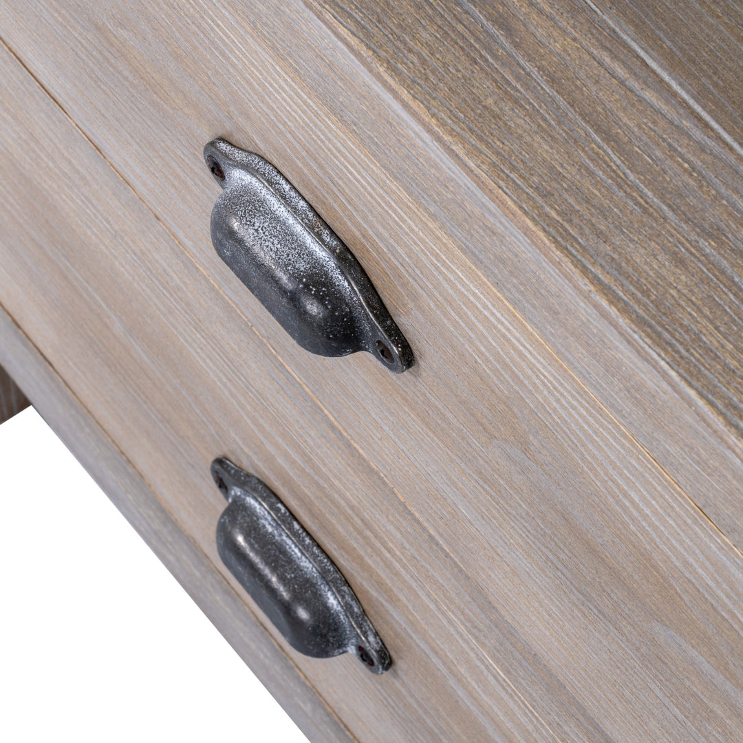 Close-up of wooden drawer with metal handles on a light wood background