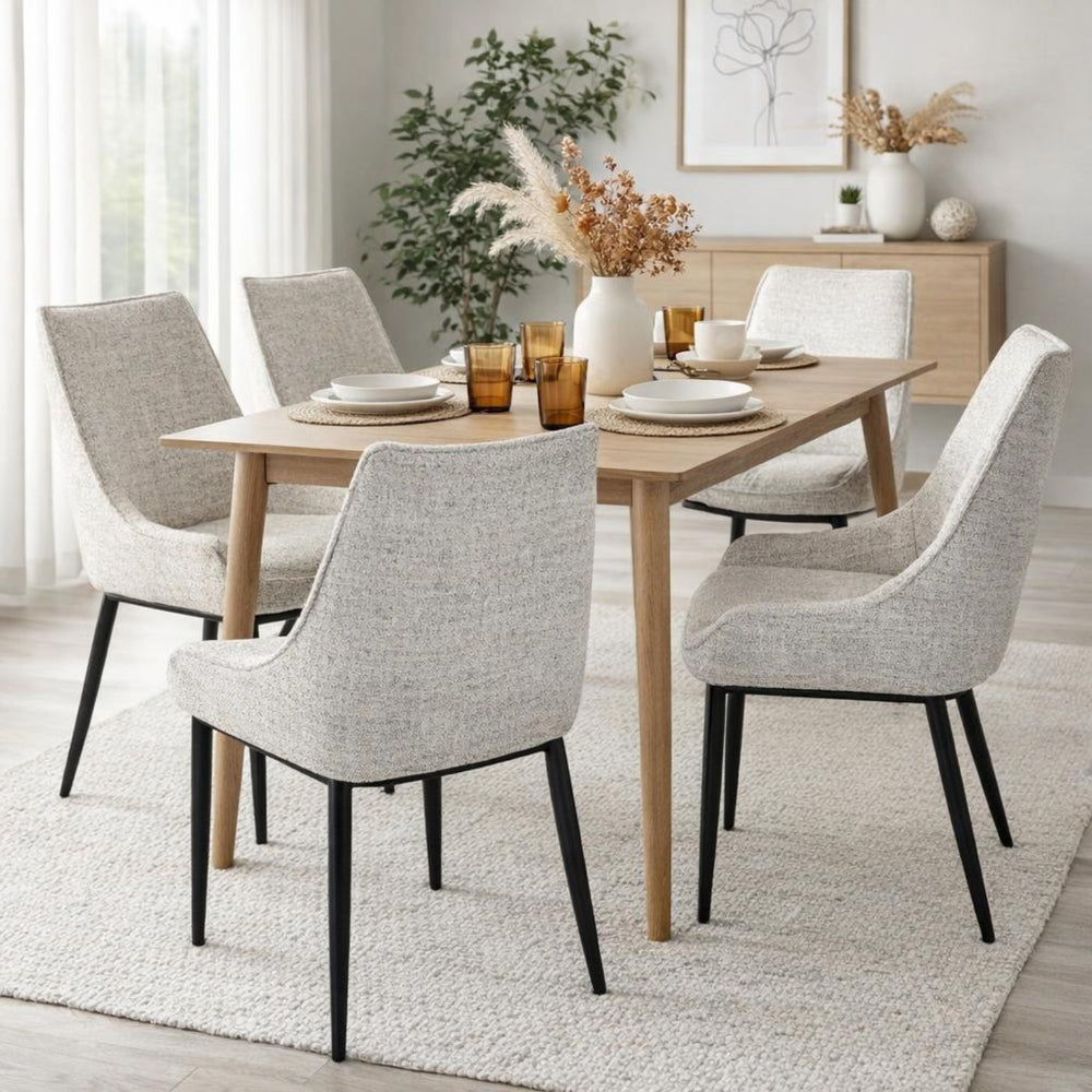Dining room with a wooden table and gray chairs on a light rug.
