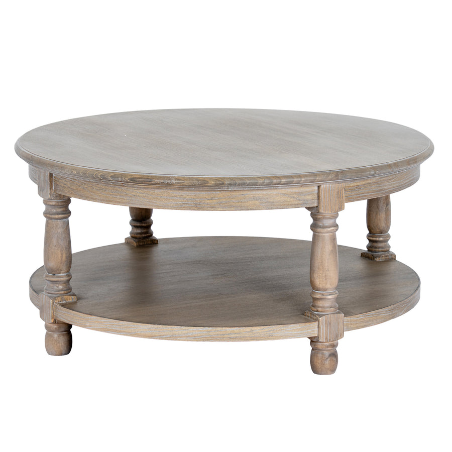 A round two-tier wooden coffee table with a distressed gray-brown finish, featuring turned legs and a lower shelf, shown against a plain white background.