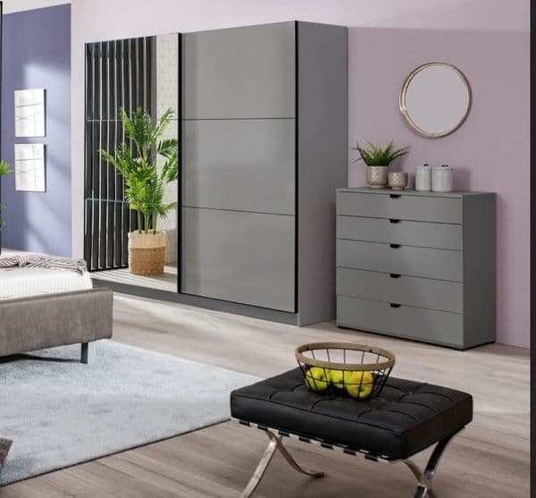 Modern bedroom with gray wardrobe, dresser, and bench.