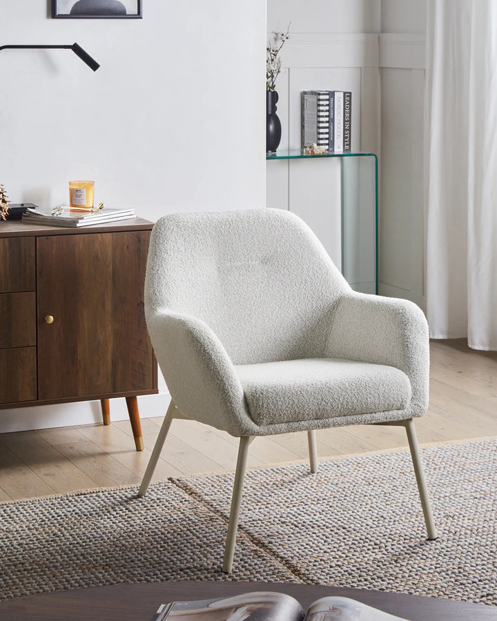 White armchair in a modern living room setting with wooden cabinet and glass shelf.