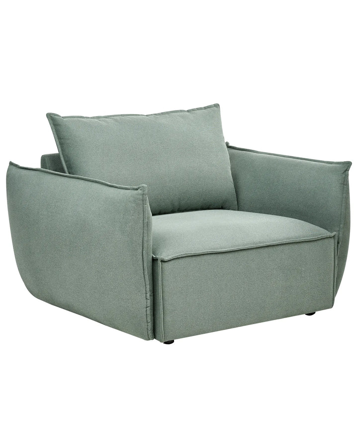 Green armchair with a pillow on a white background