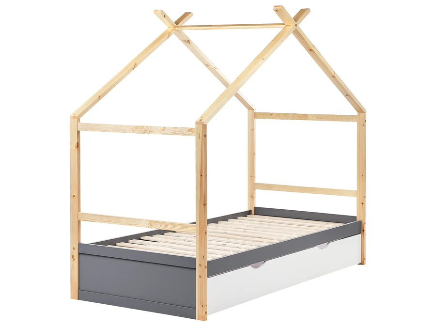 Children's bed with house-shaped canopy on a white background