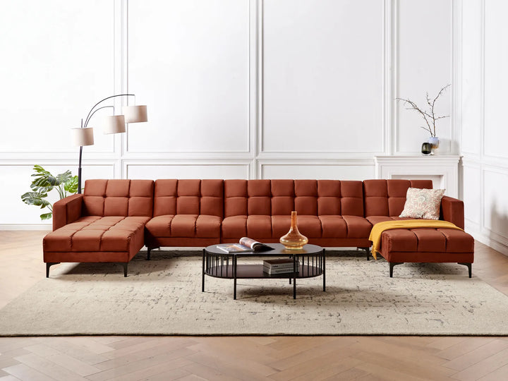 Brown sectional sofa in a living room with a coffee table and decor items.