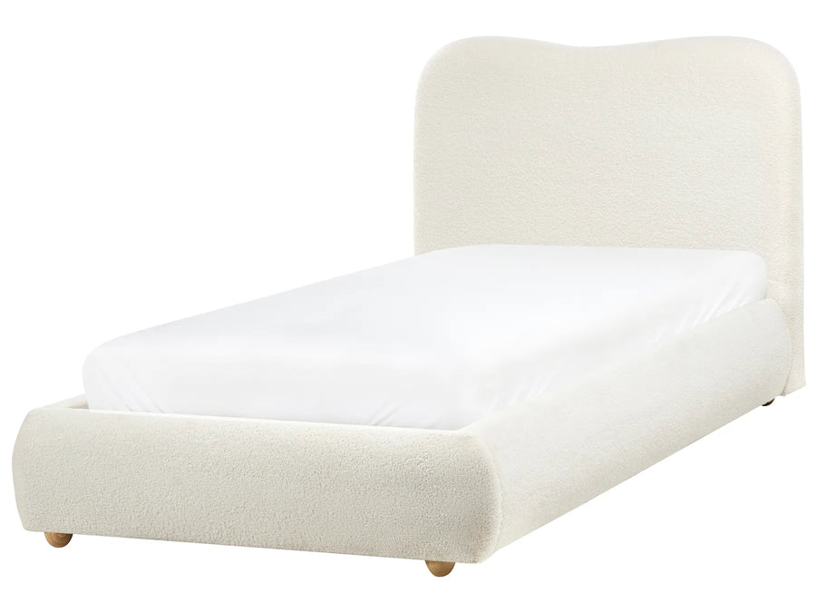 White upholstered bed with a white mattress on a white background
