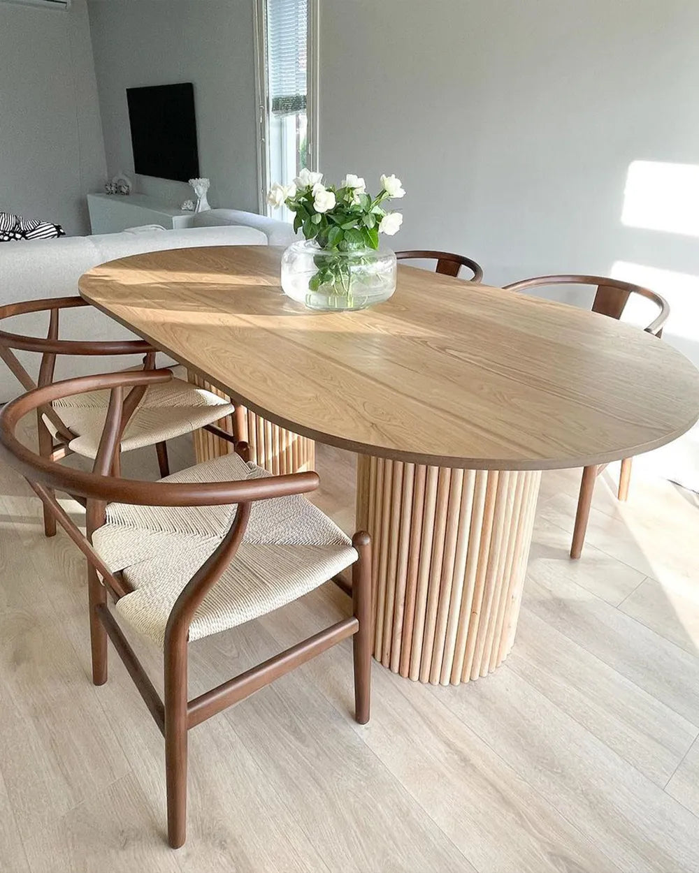 Dining area with a wooden table and chairs in a modern home setting.
