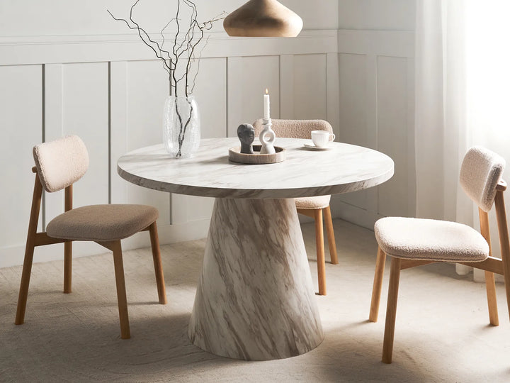 Dining table with marble base and chairs in a modern room