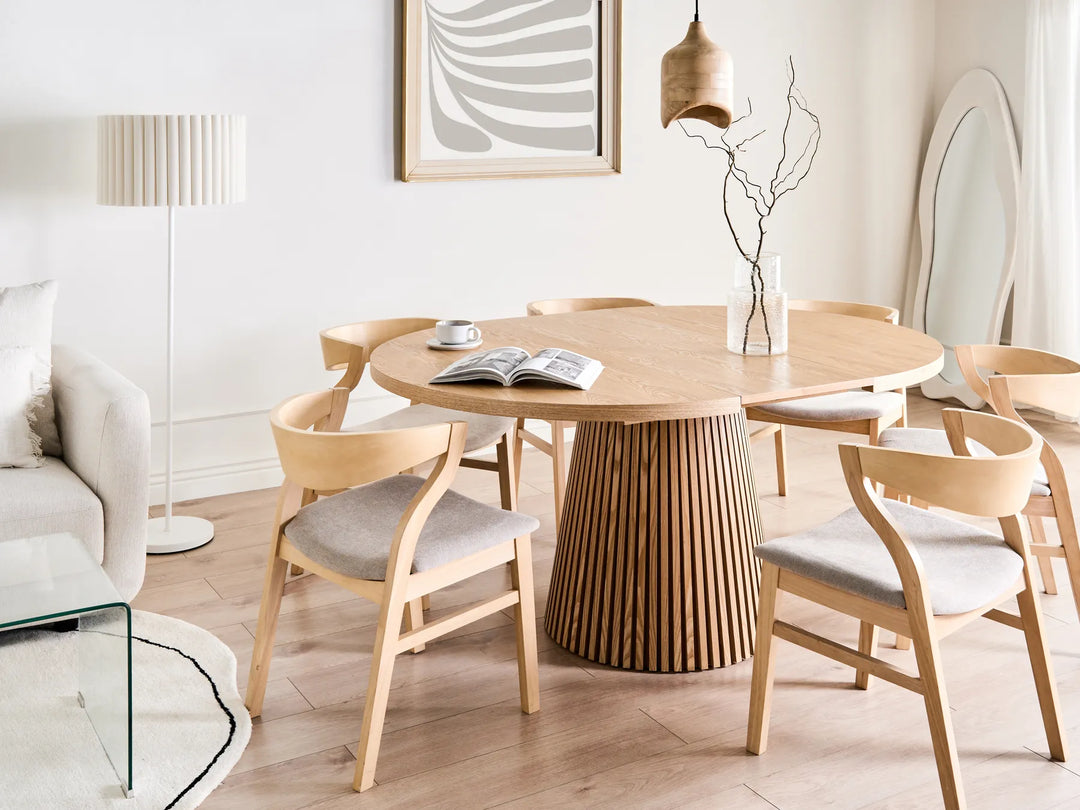 Dining area with wooden table and chairs in a modern living room.