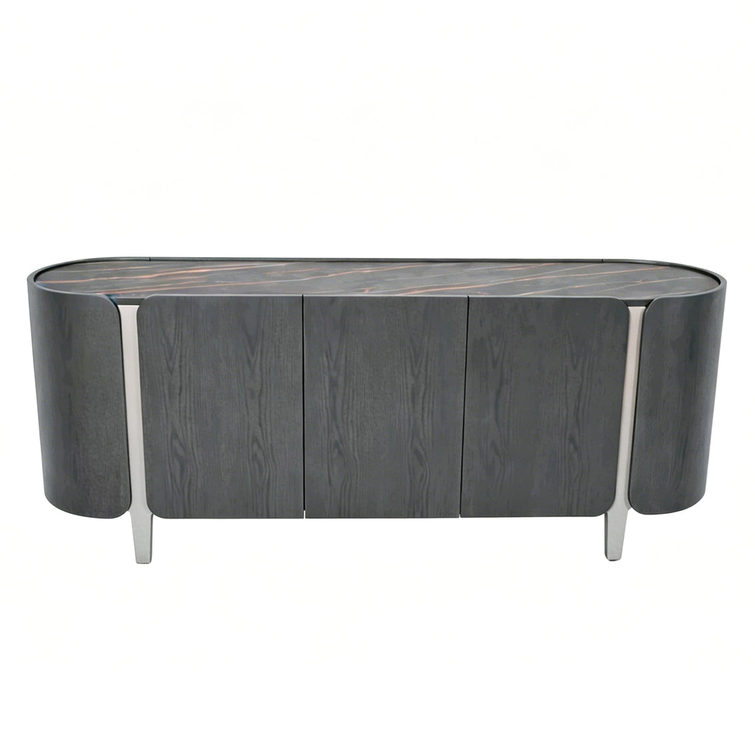 A modern sideboard or credenza with a dark gray wood grain finish, featuring three front doors, a curved top, and slim silver metal legs, shown against a plain white background.