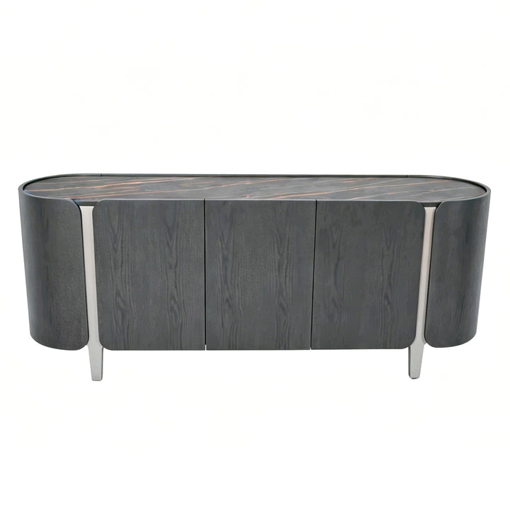 A modern sideboard or credenza with a dark gray wood grain finish, featuring three front doors, a curved top, and slim silver metal legs, shown against a plain white background.