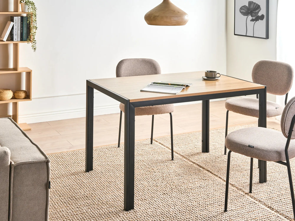 Dining area with a table, chairs, and a couch in a well-lit room.