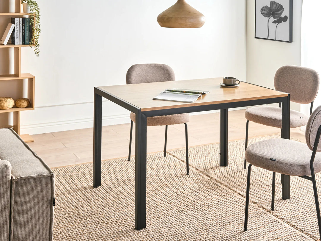 Dining area with a table, chairs, and a couch in a well-lit room.