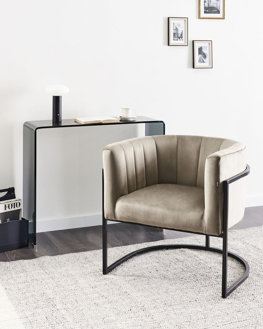 Beige armchair with black metal frame in a modern interior setting