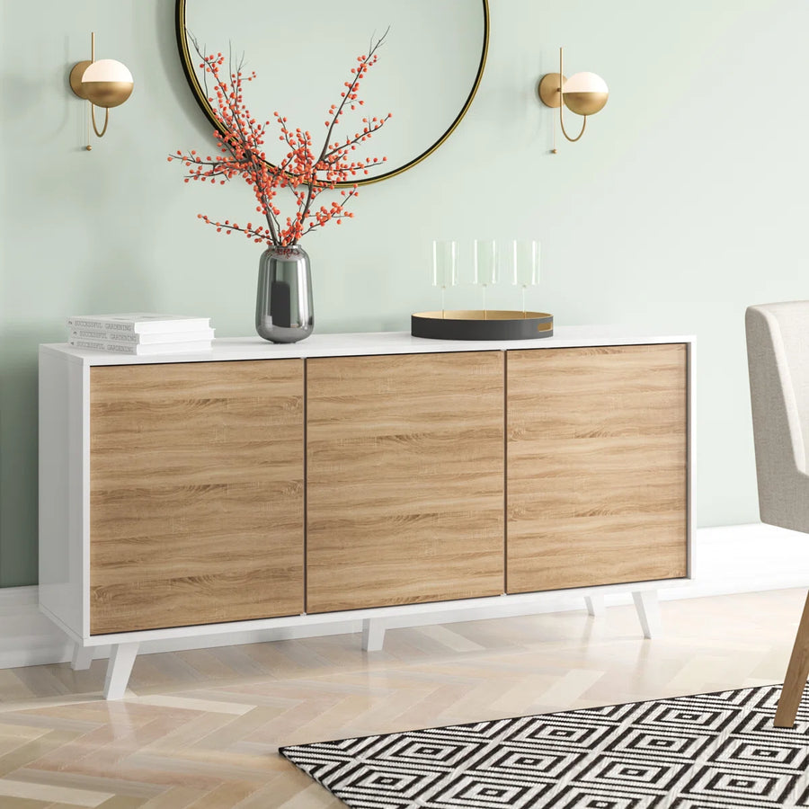 Modern sideboard with wooden doors and white base in a room with a mirror and decorative items.