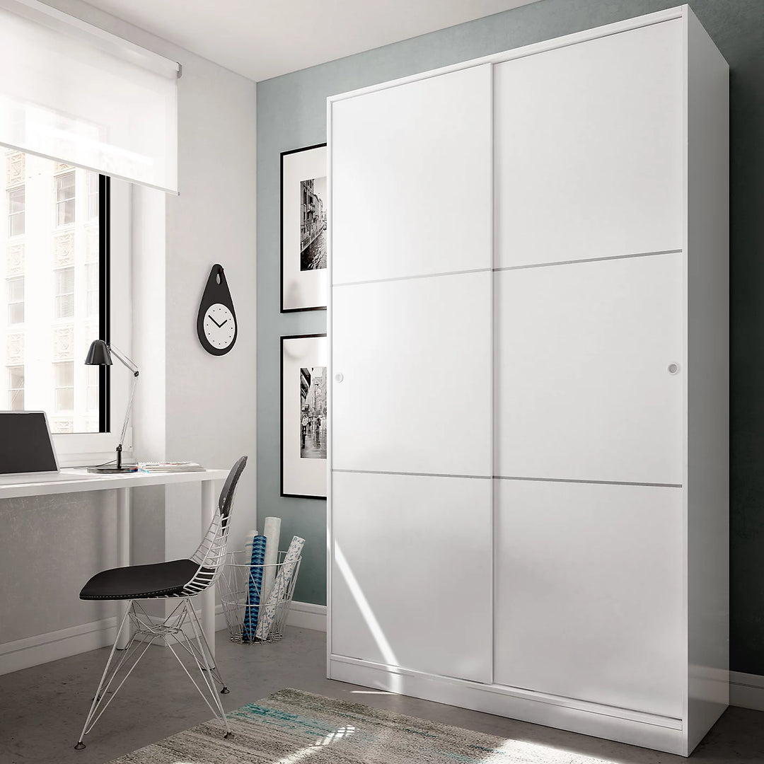 Modern bedroom with a large white wardrobe, desk, and chair.