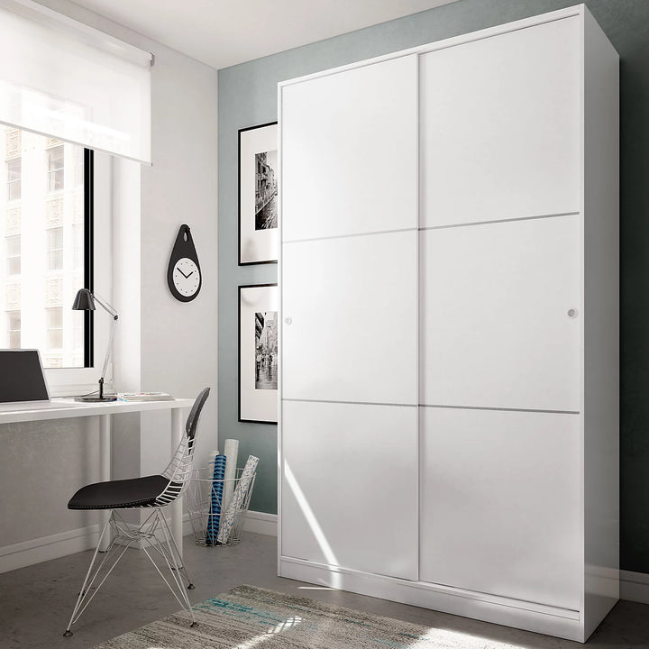 Modern bedroom with a large white wardrobe, desk, and chair.