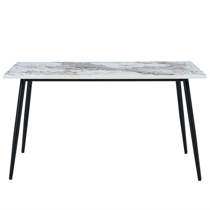 Dining table with marble-like top and black legs on a white background