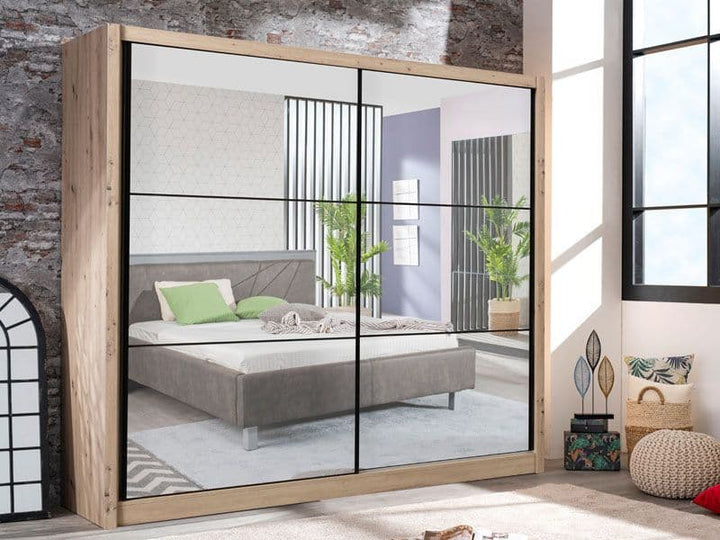Sliding wardrobe with glass panels showing a bedroom interior.