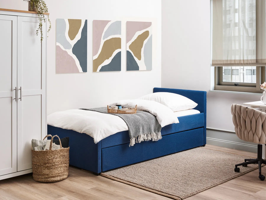 Modern bedroom with a blue bed, white wardrobe, and abstract wall art.