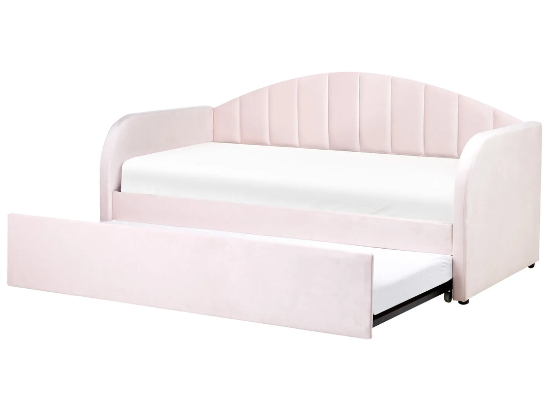 Pink upholstered bed with a white mattress on a white background