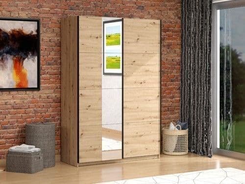 Wooden wardrobe with mirror doors in a room with brick wall and window.