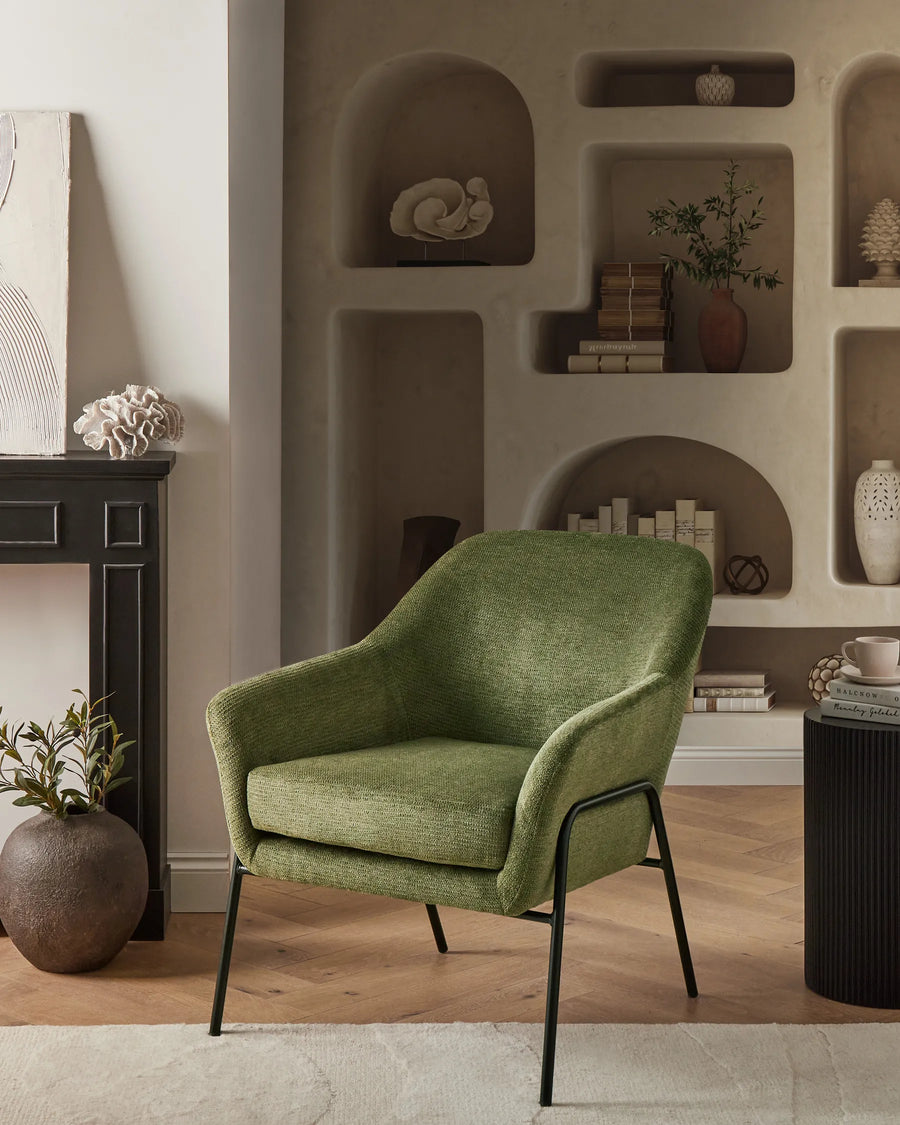 Green armchair in a room with shelves and decor