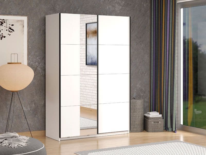 White wardrobe with sliding doors in a room with a lamp, rug, and window.