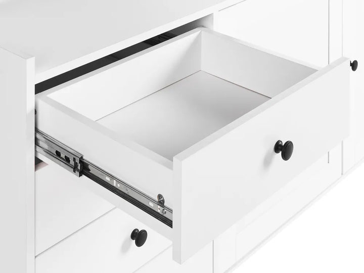 Open white drawer with black handle on a white background