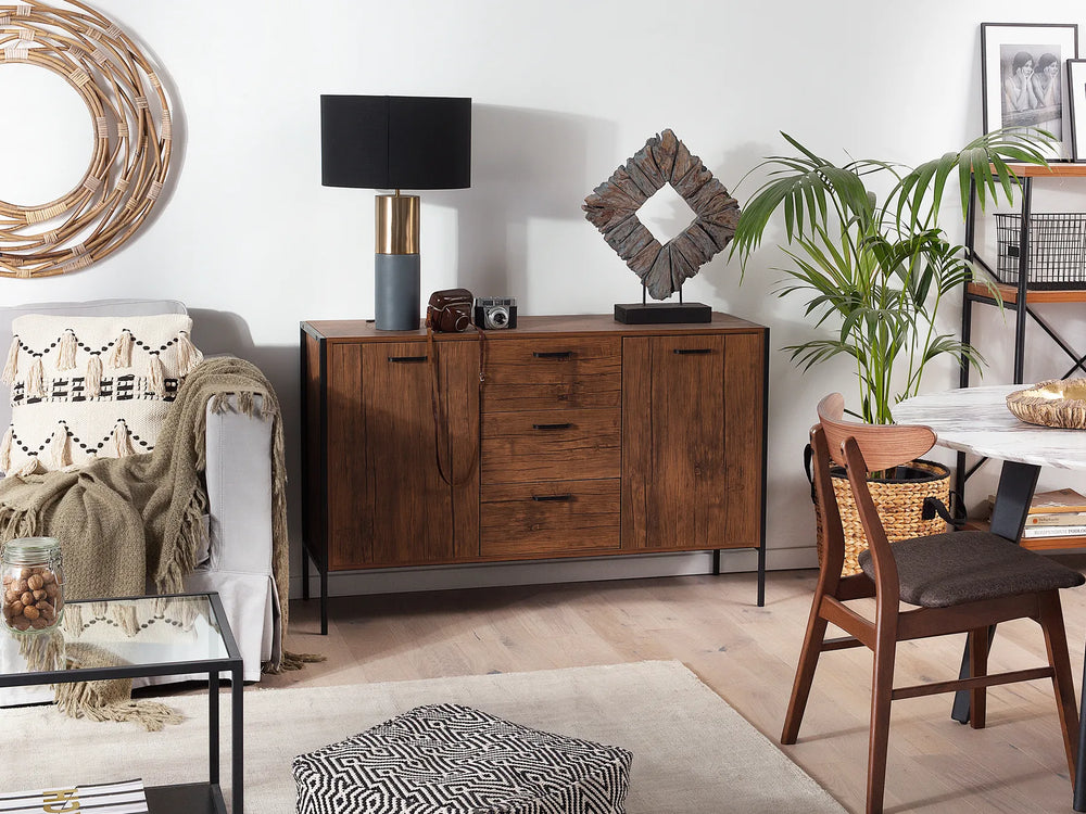 Living room with wooden sideboard, chair, and decorative items.