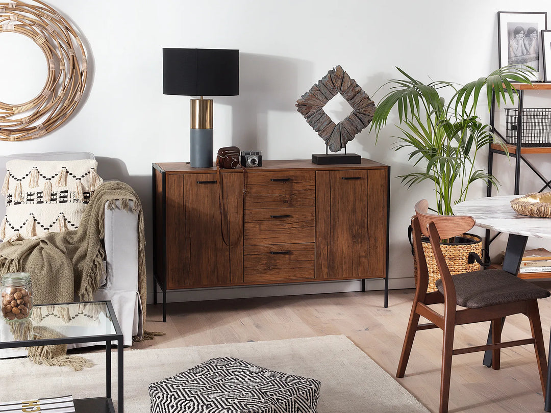 Living room with wooden sideboard, chair, and decorative items.