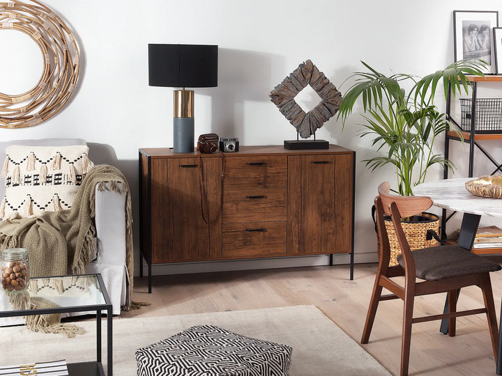 Living room with wooden sideboard, chair, and decorative items.
