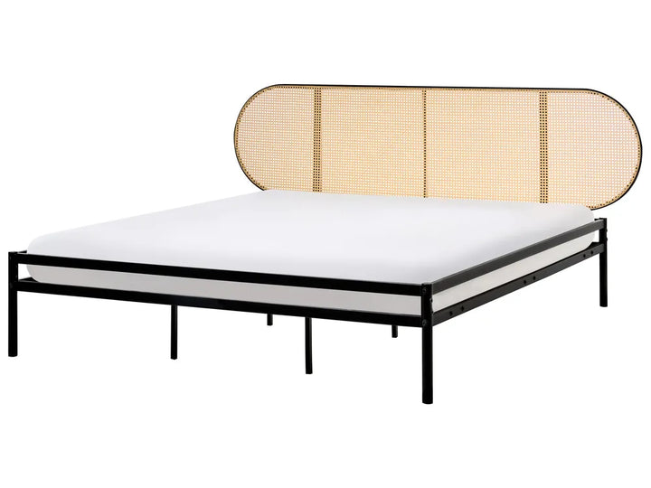 Bed with a black frame and beige woven headboard on a white background