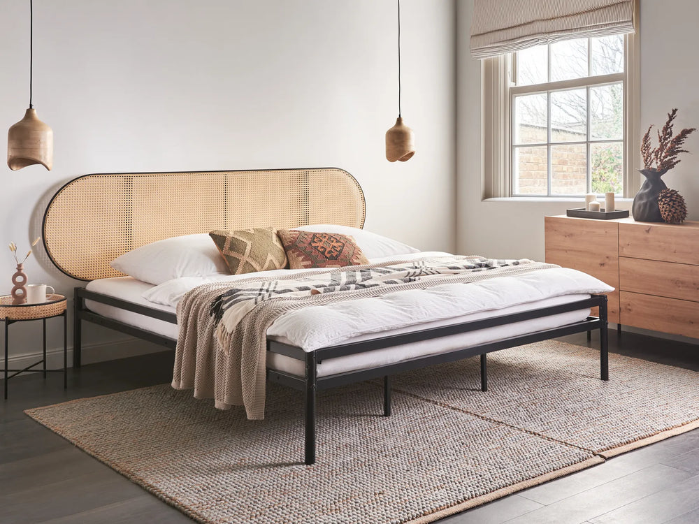 Modern bedroom with a bed, side table, and dresser.
