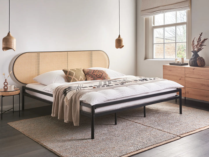 Modern bedroom with a bed, side table, and dresser.