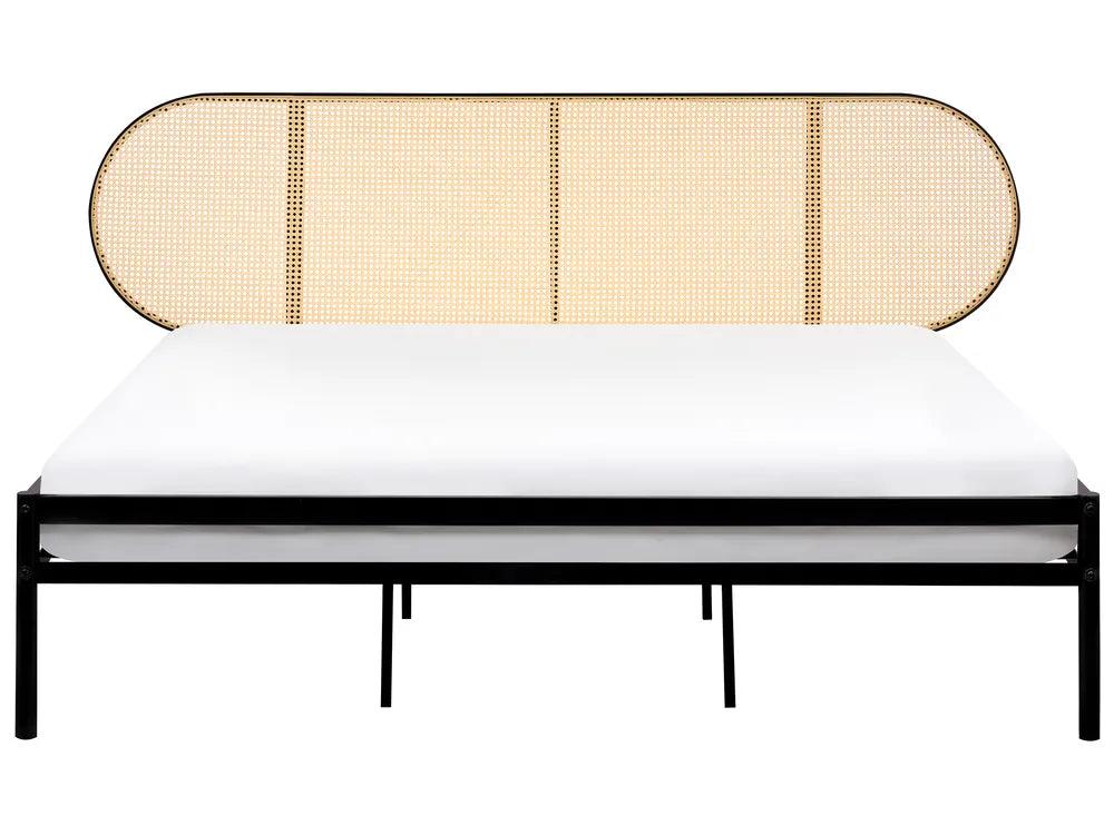 Bed with a wicker headboard and black frame on a white background