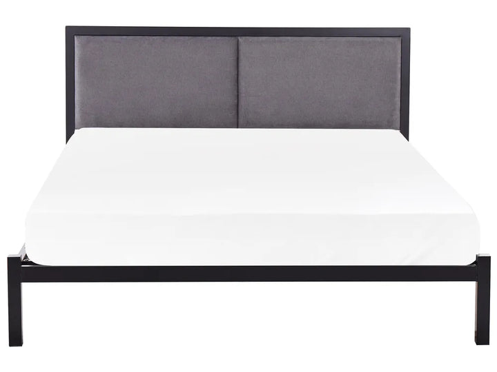 Bed with gray upholstered headboard and white mattress on a white background