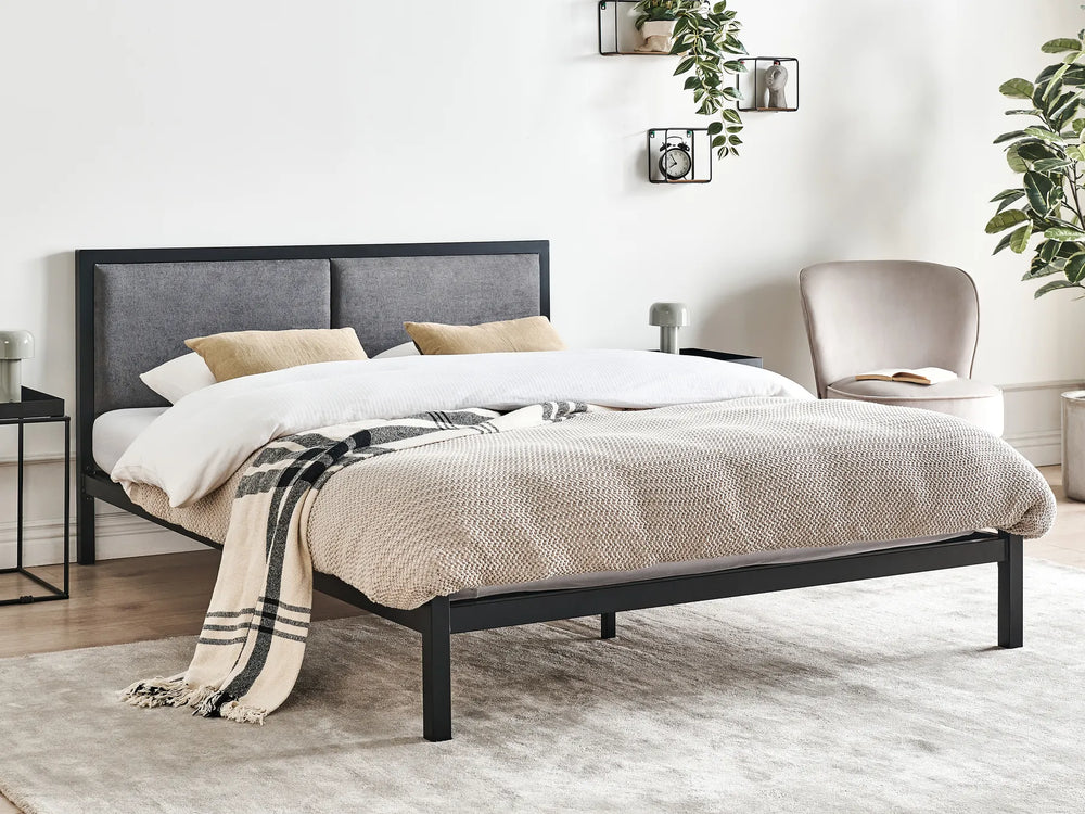 Bedroom with a bed, chair, and decorative elements
