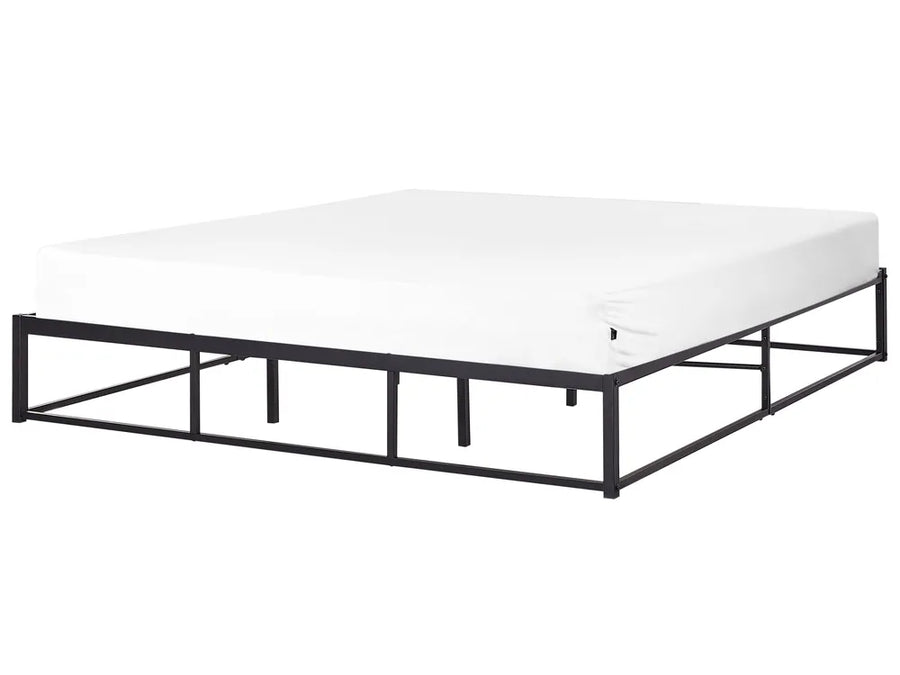 Black metal bed frame with white mattress on a white background