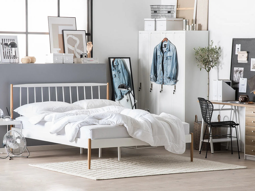 Modern bedroom with a bed, desk, and various decor items.