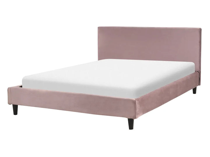 Pink upholstered bed with white mattress on a white background