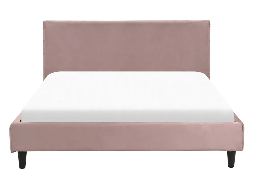 Pink upholstered bed with white mattress on a white background