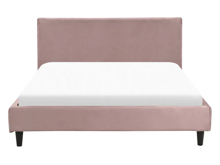 Pink upholstered bed with white mattress on a white background