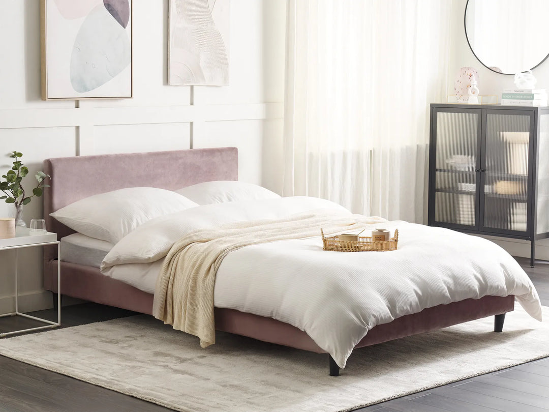 Pink bed with white bedding in a modern bedroom setting