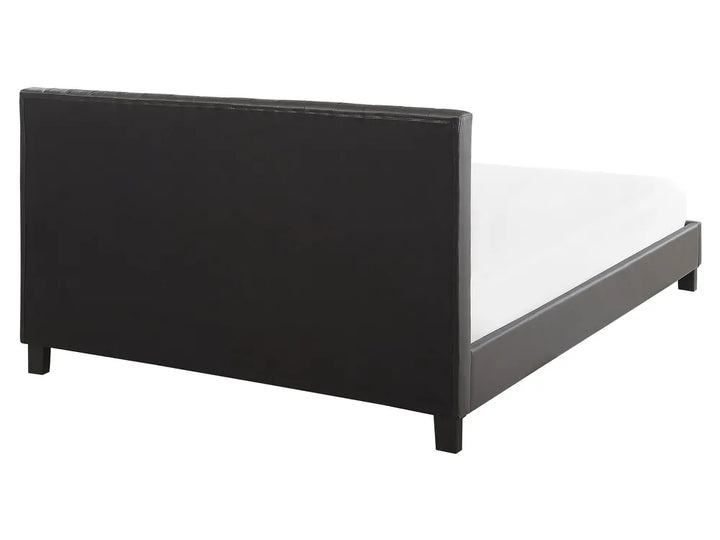 Black bed frame with white mattress on a white background