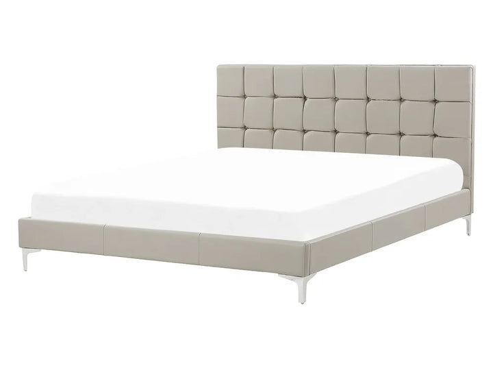 Beige upholstered bed with white mattress on a white background