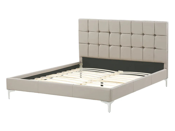 Beige upholstered bed with tufted headboard on a white background