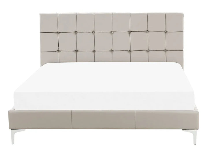 Beige upholstered bed with tufted headboard on a white background
