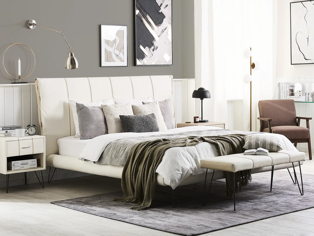 Modern bedroom with a white bed, nightstands, and decor.