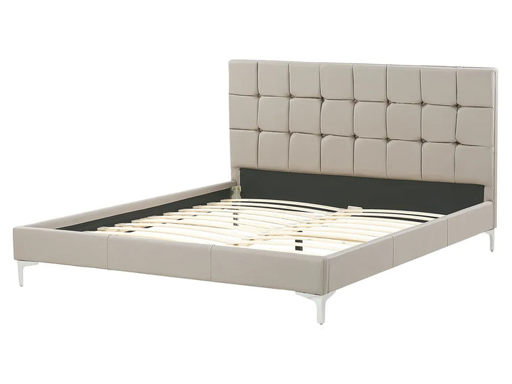Beige upholstered bed frame on a white background